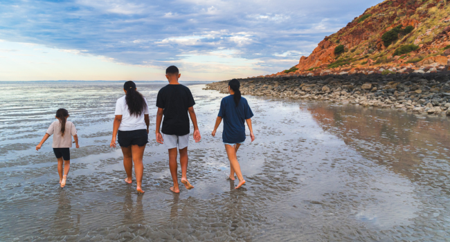 Young people walking on a beach near Karratha